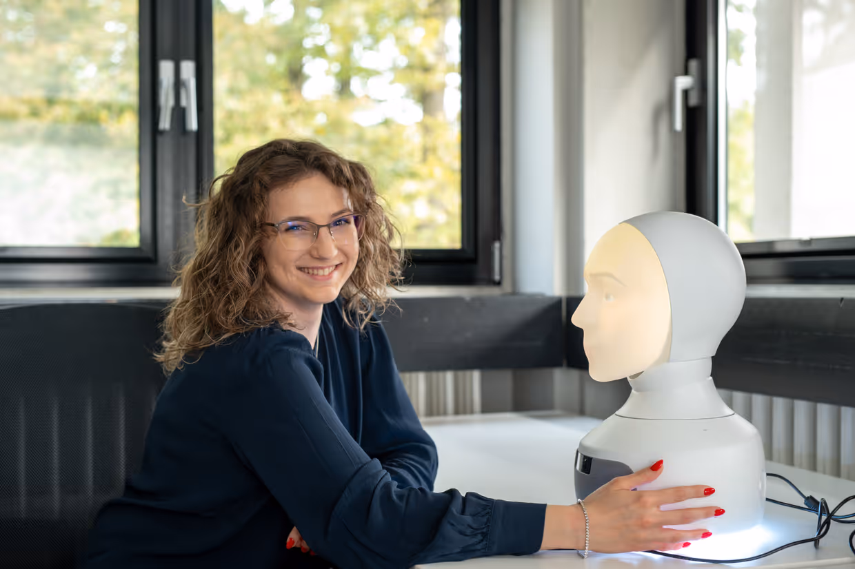 Lab employee using the social robot Furhat.