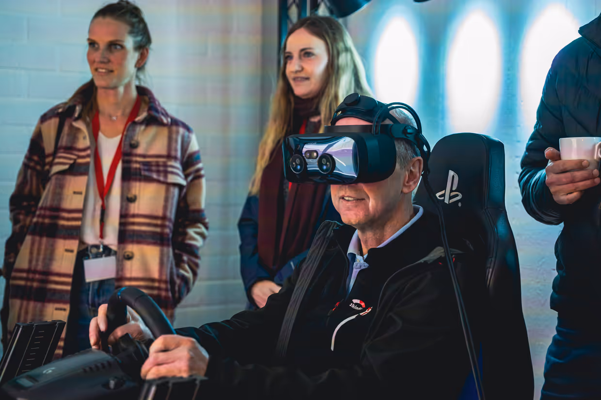 A Man using the driving simulator with VR.