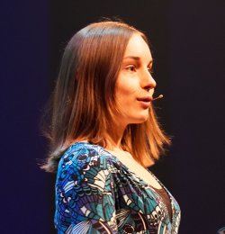 Clara giving a lecture at a conference